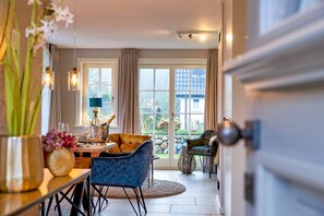 A dining area with a table, chairs, and a view of the outside.