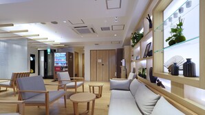 A modern hotel lobby with seating areas, a vending machine, and decorative shelves. - Far East Village Hotel Tokyo, Asakusa (Tokyo)