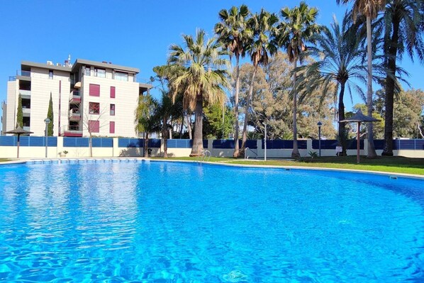 A swimming pool with a building in the background.