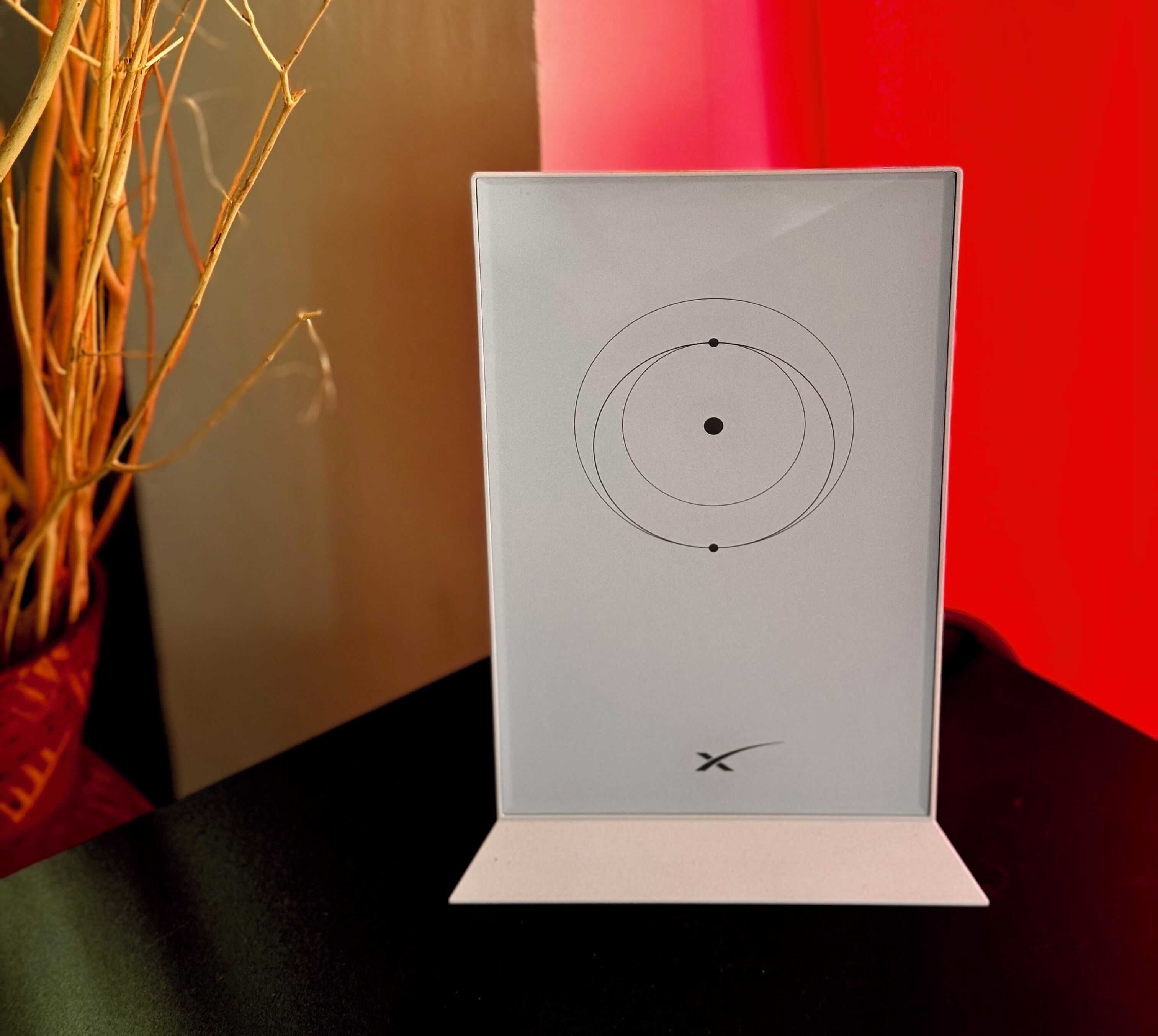 A white display stand with a diagram of a planetary system.