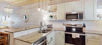 2-story home near the beach with outdoor pool, patio, washer/dryer, AC, & WiFi