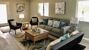 A living room with a sofa, armchairs, a coffee table, and a rug. - Wine Country Hilltop Home w/Views & Pool & Spa - New Listing! (Temecula)