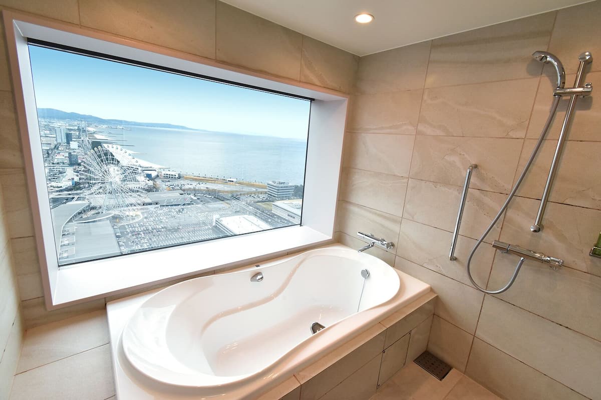 deluxe suite | bathroom | deep-soaking bathtub, free toiletries, hair dryer, slippers