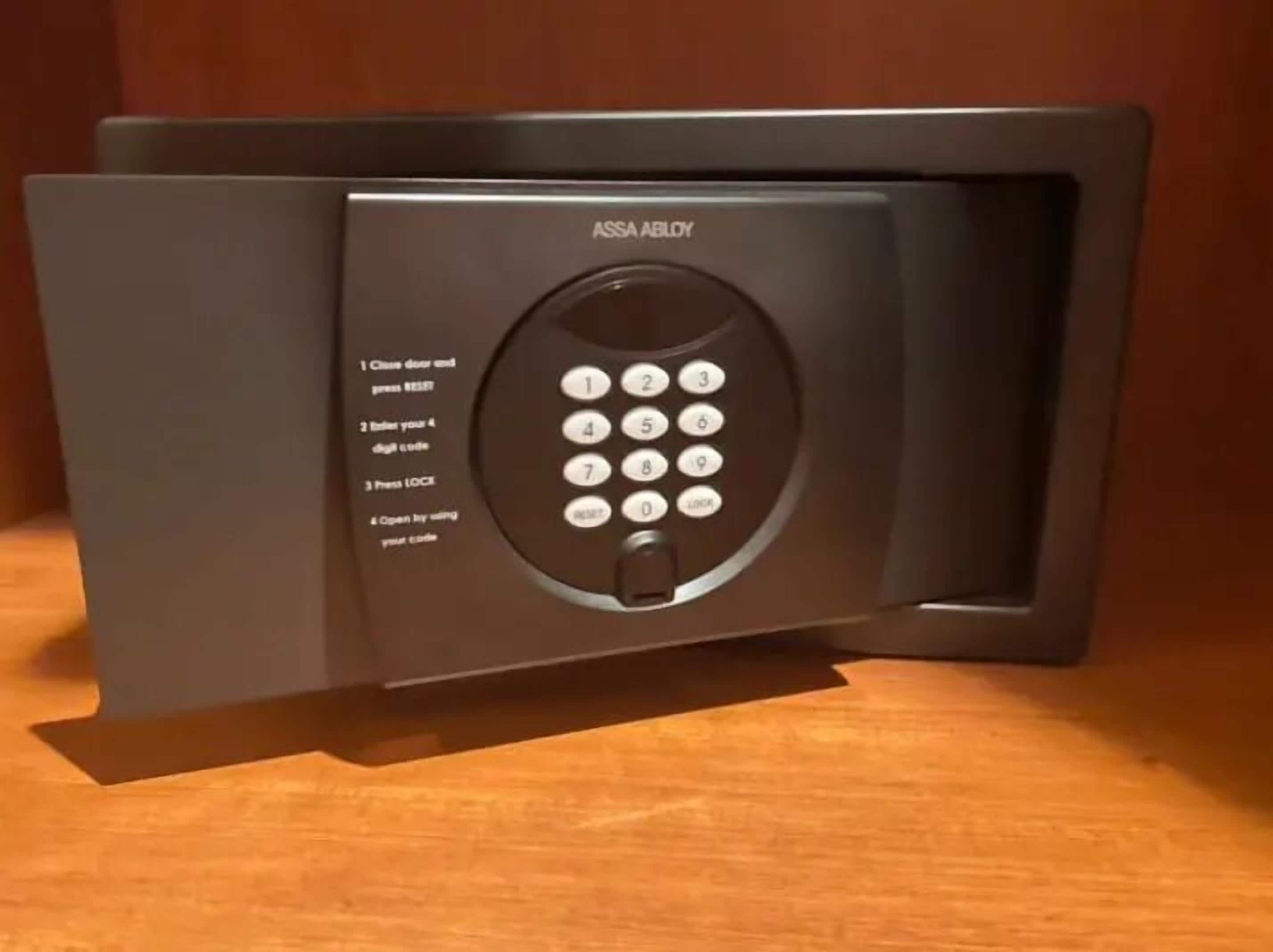A black electronic keypad lock with instructions for use.