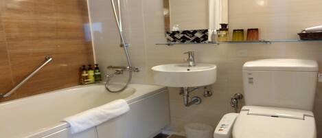 A modern bathroom with a bathtub, a sink, and a toilet.