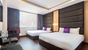 A hotel room with two beds, a desk, and a window with curtains. - MAY'S HOTEL-BEN THANH MARKET (Ho Chi Minh City)