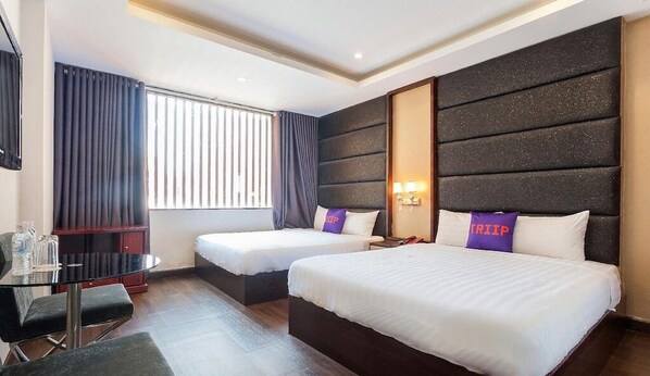 A hotel room with two beds, a desk, and a window with curtains. - MAY'S HOTEL-BEN THANH MARKET (Ho Chi Minh City)