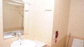 A bathroom with a white sink, mirror, and toilet. - MAY'S HOTEL-BEN THANH MARKET (Ho Chi Minh City)