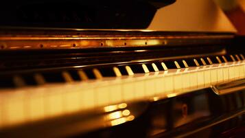 A close-up of a piano keyboard with a reflective surface.
