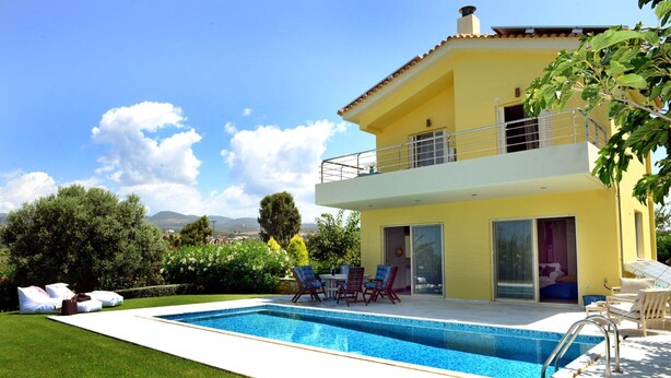 A two-story house with a swimming pool, outdoor furniture, and a view of the landscape. - Citron Pale Villa with Private Pool (Trifylia)