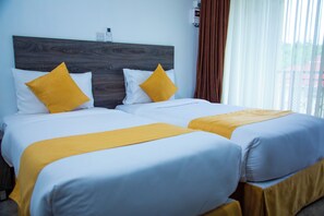 A hotel room with two beds, each with white bedding and a yellow accent pillow. - Kisimani Eco Resort & Spa (Isiolo)
