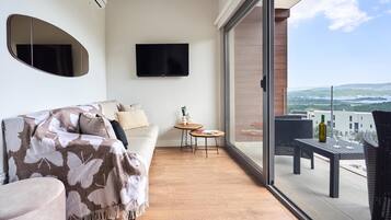 A balcony with a sofa, a small table, and a chair.