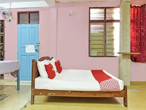 A room with a bed, a sink, a blue door, and a window with curtains. - OYO 90740 Paddington Lodge (Kota Bharu)