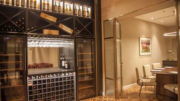 A wine cellar with wine racks and a bar area.