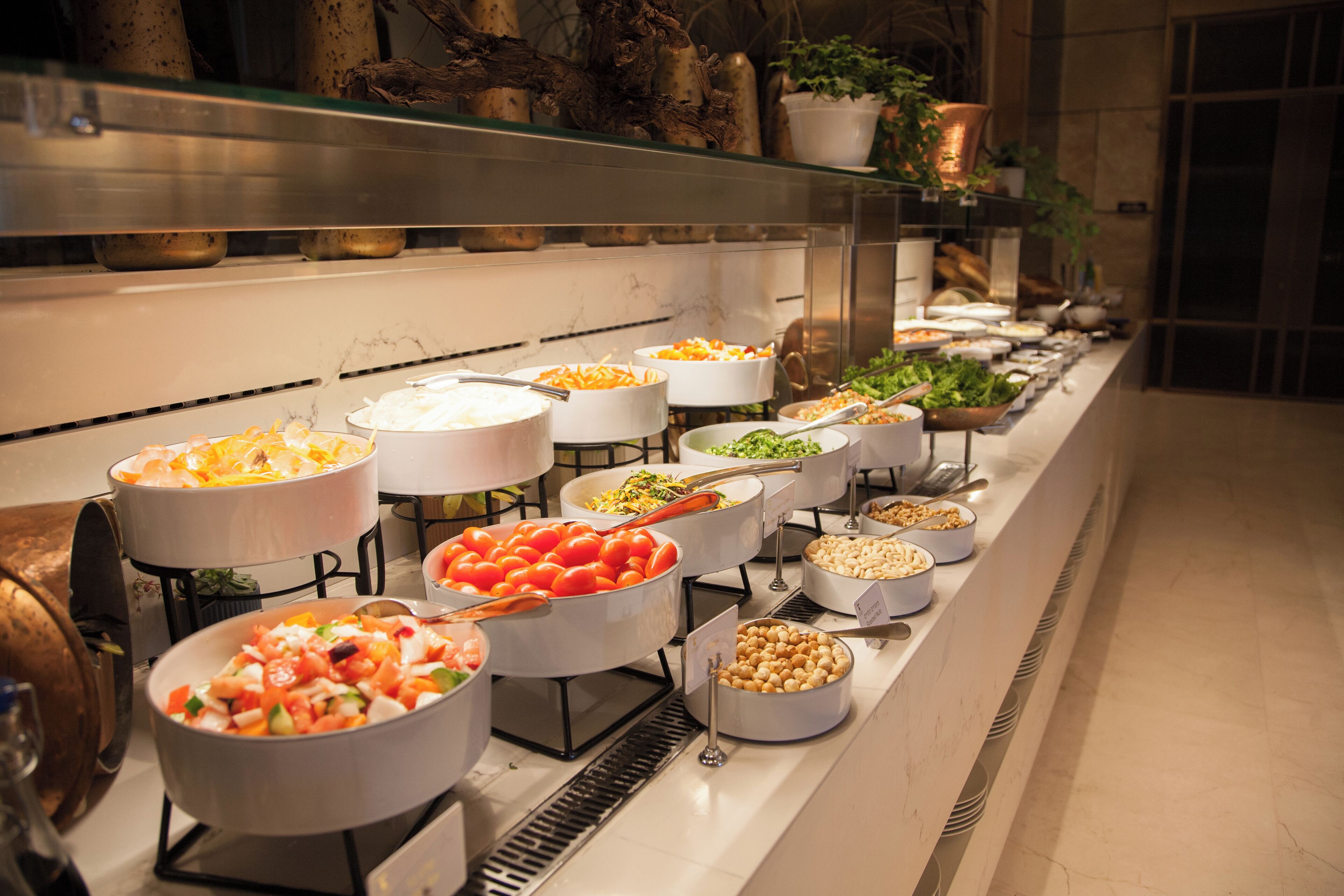 A buffet with various food items and serving utensils.