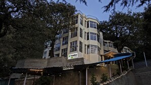 A multi-story building with a sign for 'treebo trend ANAMIKA'. - Treebo Kosmos Anamika, 1 Km From Nainital Lake (Nainital)