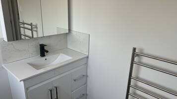 Shower, hair dryer, towels, toilet paper