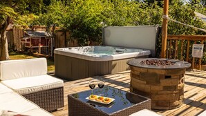 A hot tub, outdoor seating area, and a stone fire pit on a wooden deck. - Hot Tub! Pets! Green  Clean-Walking Distance to Proctor District (Tacoma)