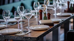 A dining table set with plates, glasses, and cutlery, with a wooden table and chairs. - Teghenis Resort (Tsaghkadzor)