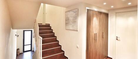 A staircase leading to a landing with a door at the top.