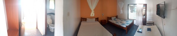 A narrow hallway leading to a bedroom with two beds, a TV, and a bedside table with a remote control. - Comfy Dhows Hotel, Kilifi (Kilifi)