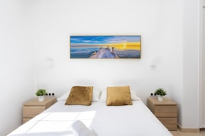 A bedroom with a bed, two nightstands, a painting, and a window. - Fantastic home with amazing sea views (El Sauzal)