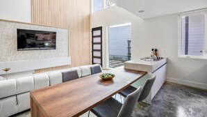 A modern kitchen with a wooden countertop and a built-in oven.