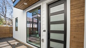 A modern house with a sliding glass door and a garage door.