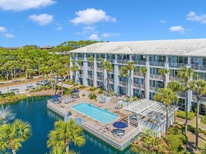 Relax by the hotel's large rectangular pool surrounded by a deck with lounge chairs and umbrellas.