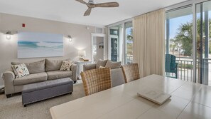 Enjoy a serene view of palm trees and a clear sky from the large window in this stylish room.
