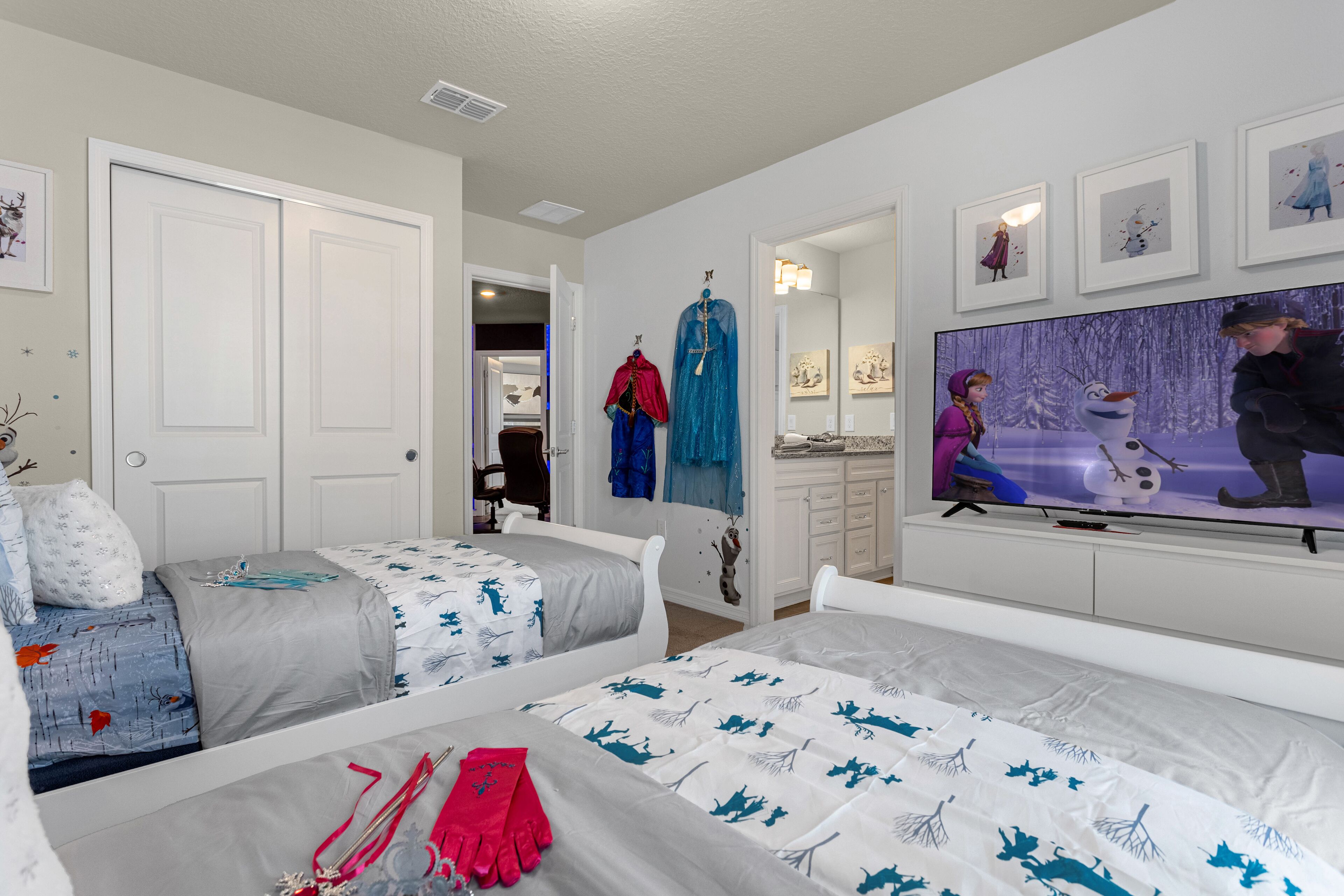 Un dormitorio con dos camas, un televisor y un armario.