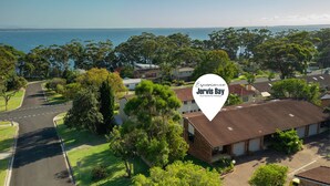 A residential area with houses, a road, and a body of water in the background. - Orion Retreat by Experience Jervis Bay (Vincentia)