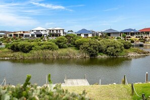 A residential area with houses, a dock, and a body of water.