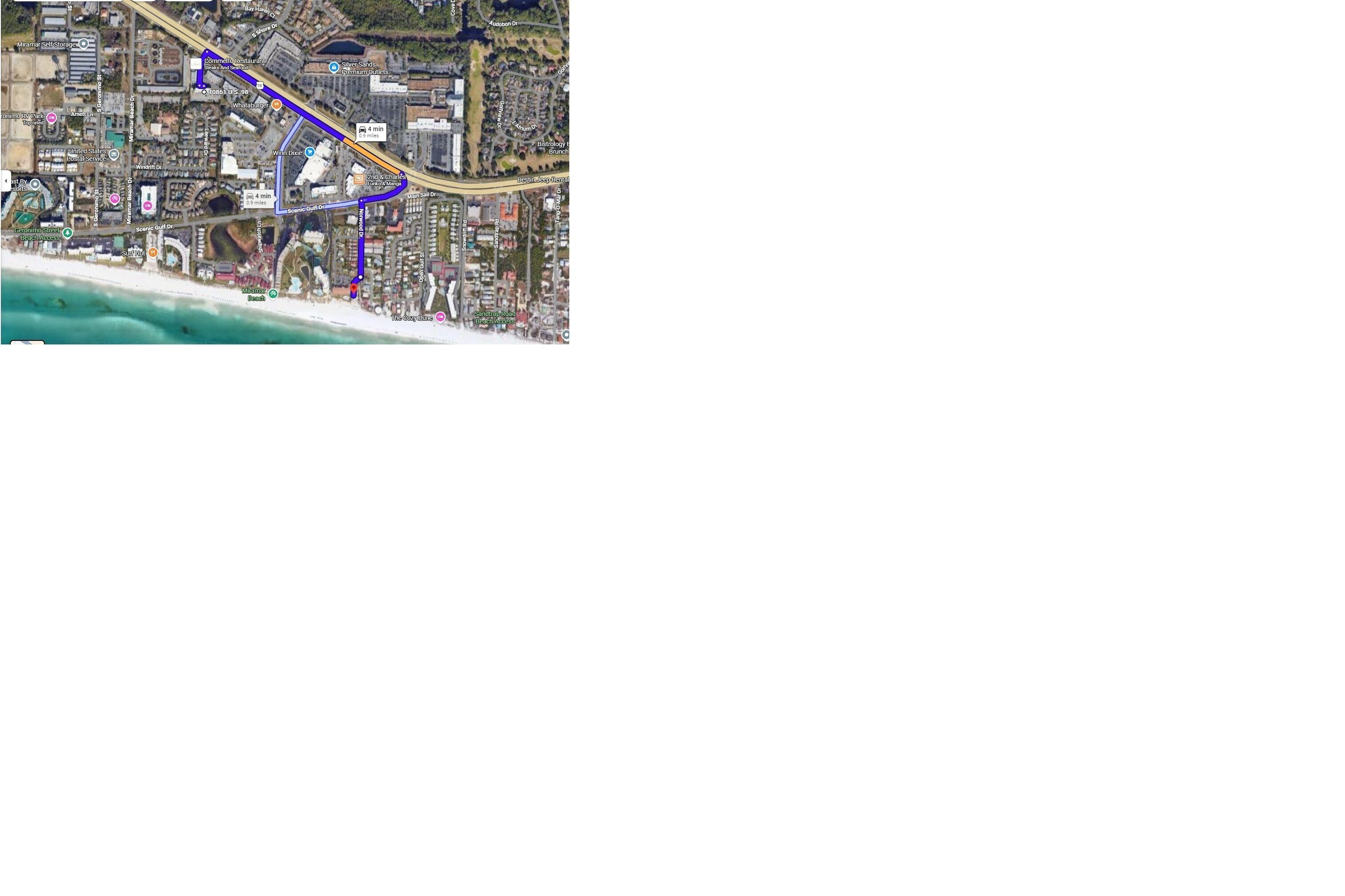 A satellite view of a coastal city with a prominent blue route.