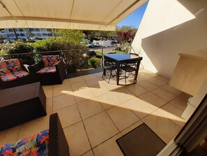 Relax on the balcony with a sofa and dining table, taking in the view of the surrounding area.