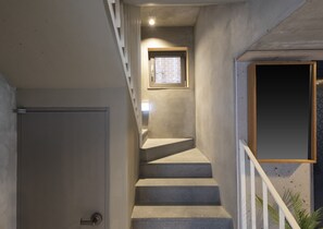 A staircase with a handrail, a door at the bottom, and a small window at the top. - Designers ON:the zip in Mangwon 202 (서울특별시)