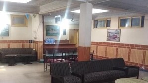 A spacious lobby with a seating area, a dining section, and a patterned ceiling. - Hotel AL-Habib  (Islamabad)