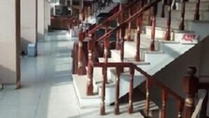 A spacious interior with a central staircase, tiled floors, and a high ceiling. - Hotel AL-Habib  (Islamabad)