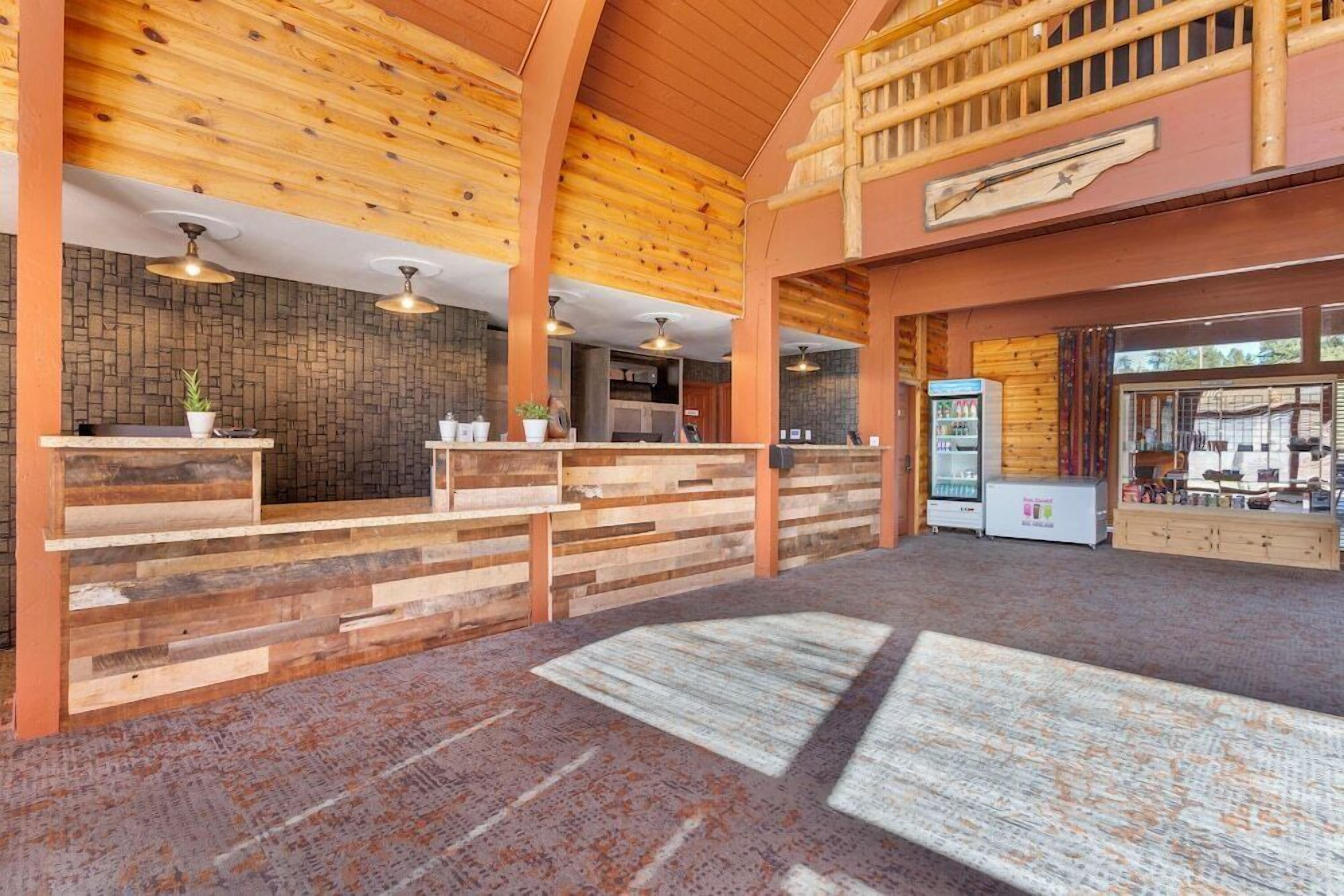 A reception area with wooden paneling, a stone wall, and a vending machine.