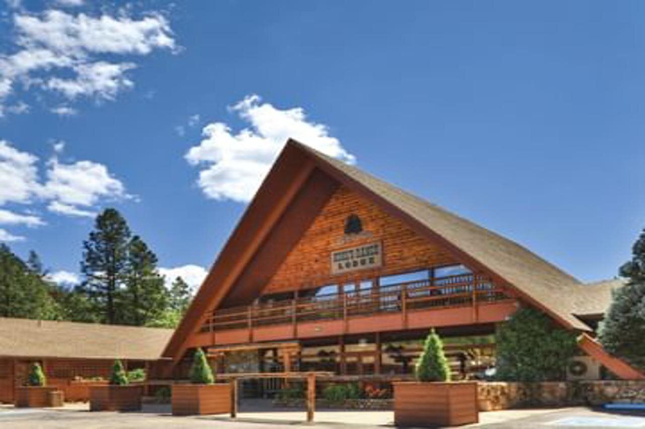 A large, wooden lodge with a prominent triangular roof and multiple balconies.