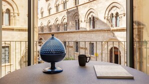 A balcony with a table, a decorative globe, a mug, and a book. - Royal Suite (Trapani)