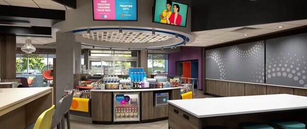 A modern cafe with a central counter, seating area, and a large window. - Tru By Hilton Destin (Destin)