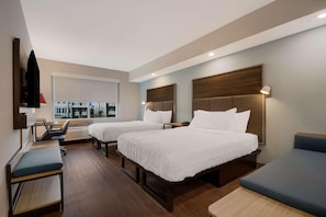 A hotel room with two beds, a desk, a chair, and a TV on the wall. - Tru By Hilton Destin (Destin)