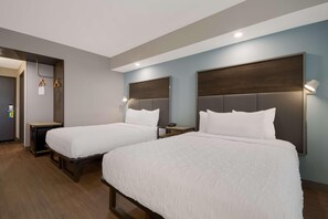 A hotel room with two beds, a desk, and a wardrobe. - Tru By Hilton Destin (Destin)
