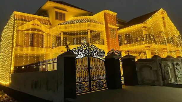 A building with multiple levels and a gated entrance, illuminated by string lights. - Vehra Shagana Da, 4bhk, 2living (Jalandhar)