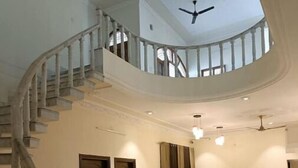A spacious interior with a marble floor, a curved staircase, and a ceiling fan. - Vehra Shagana Da / 8 bedrooms/ Punjab (Jalandhar)
