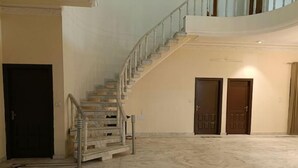 A spacious interior with a marble floor, a staircase, and two doors. - Vehra Shagana Da / 8 bedrooms/ Punjab (Jalandhar)