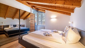 A bedroom with a wooden ceiling, two beds, and a window. - Holiday Apartment "Luisa" with Mountain View, Private Terrace & Wi-Fi (Schlanders)