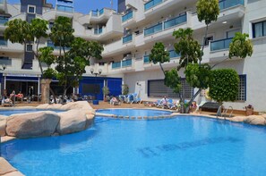 A swimming pool with lounge chairs, a building with balconies, and a sign for 'Plaza Marina II Parthenon'. - Holiday Apartment "En El Cabo Roig" with Shared Pool, Private Balcony & Wi-Fi (Orihuela)