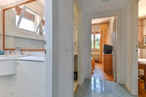 A bathroom with a sink, mirror, and toilet.